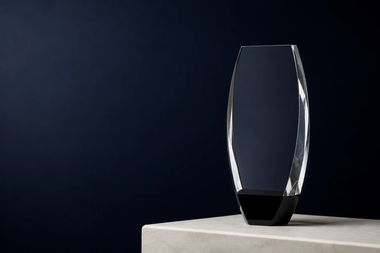 Crystal corporate award with a softly lit workshop background