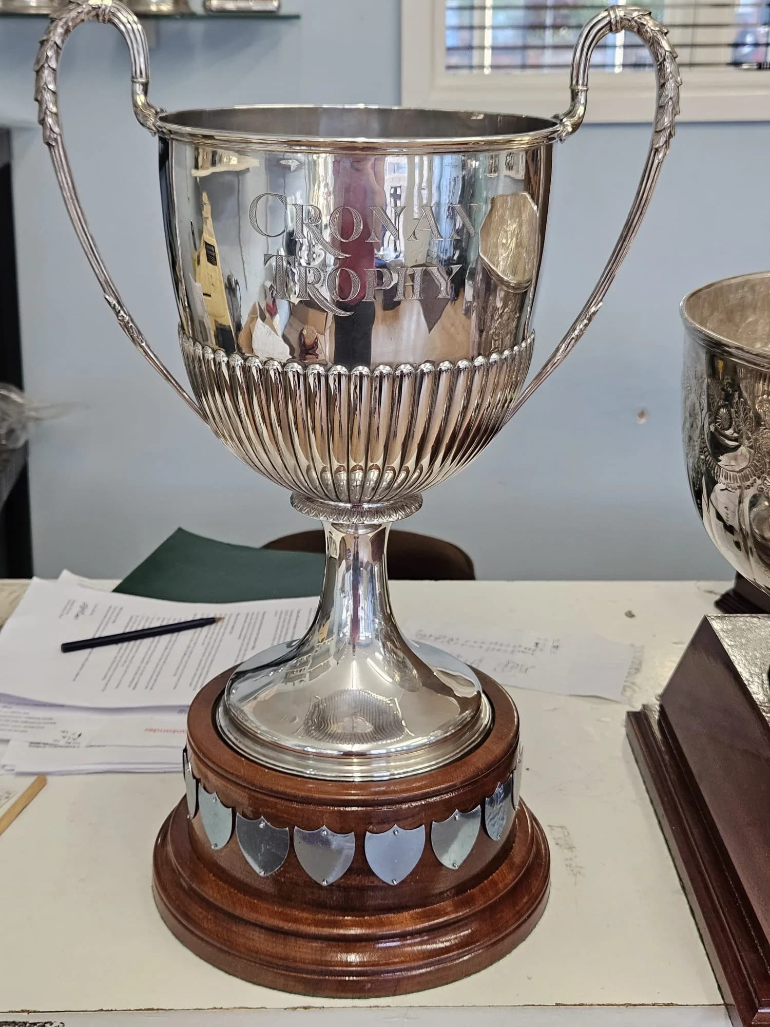 Engraved Crown Trophy silver cup on its wooden perpetual base